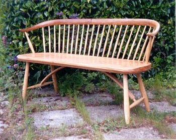 Oak bench with bent back.